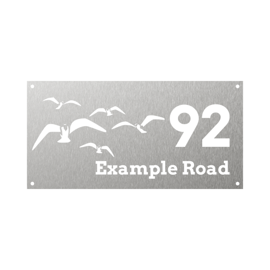 Rectangular metal steel house number with flock of seagulls flying